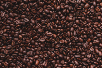 Coffee beans background. Brown roasted coffee beans taking up the whole frame.