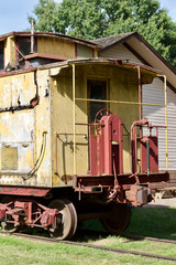Fototapeta na wymiar Close up view of an antique deteriorated wooden railway train caboose