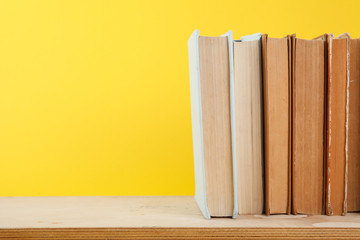 Stack of books on yellow background