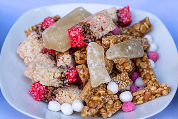 Thai sweet cereal bar made of rice, nut, sesame seeds and sugar on plate for Thai engagement ceremony. Nuts dessert in Thailand