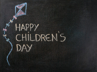 Fototapeta na wymiar Blackboard written Happy Children's Day. Copy space.