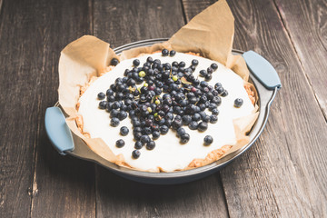Fresh cheesecake with wild blueberries on the rustic background. Selective focus. Shallow depth of field.