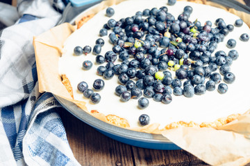 Fresh cheesecake with wild blueberries on the rustic background. Selective focus. Shallow depth of field.