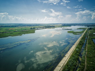 Aerial view of blue river whit reflections on a sunny summer day. Drone photography. River Olt, Romania.