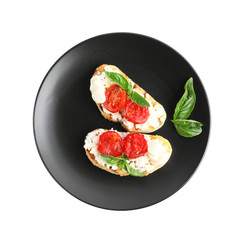 Tasty fresh tomato bruschettas on white background