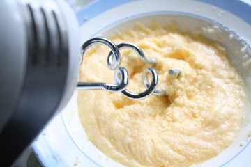 Mixer whips the mixture in a bowl