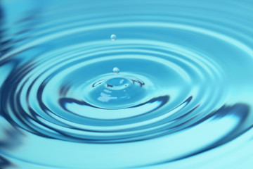 Naklejka na ściany i meble Splash of blue water with drop, closeup