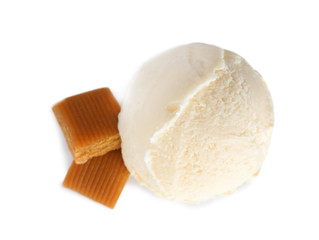 Scoop of delicious ice cream with caramel candies on white background, top view