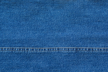 Blue denim jeans with seam background. Jeans texture
