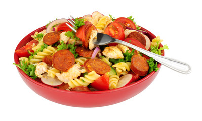 Chorizo and chicken pasta salad bowl isolated on a white background