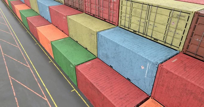 High angle view of rows of cargo shipping containers at transportation port harbor. Shipping containers painted in colors of transportation company. Seamless loop