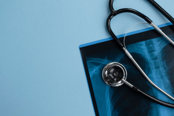 X-ray, medical stethoscope on a blue background. Healthcare and medical concept. Copy space