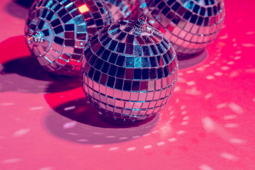 Mirror disco balls over pink background. Party, nightlife concept
