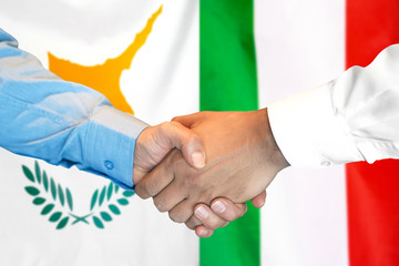 Business handshake on the background of two flags. Men handshake on the background of the Cyprus and Italy flag. Support concept