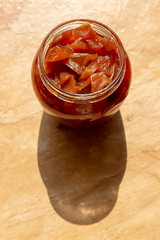 The harvestable fruit (berry) jam is a Sunny day, casting a shadow on the table with the texture of marble.