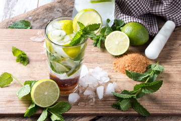 Mohito lime drinks on wooden background. 