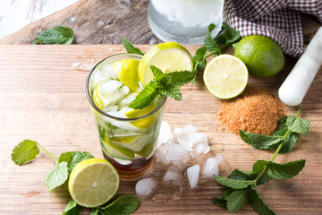 Mohito lime drinks on wooden background. 