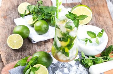 Mohito lime drinks on wooden background. 