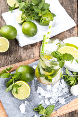 Mohito lime drinks on wooden background. 