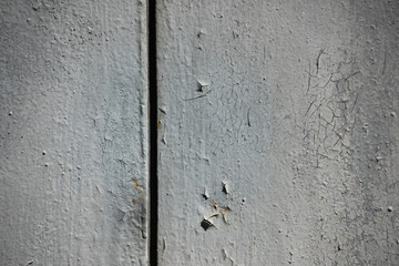 Old rough wall with cracked and peeling paint