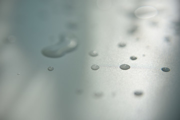 drops of water on white surface with shadow