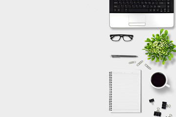 Top view office desk with laptop, pen, notebook, paper clip, glasses, Flower vase, coffee, supplies, with copy space background. Creative flat lay photo of workspace desk