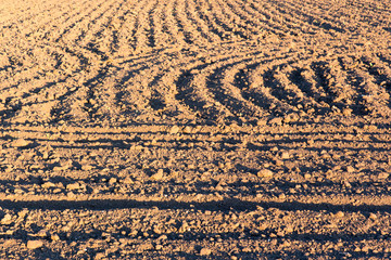 Naklejka premium ploughed field or arable land with textured pattern after burying