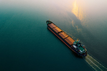 Shipping cargo to harbor by ship. Water transport International. Aerial view