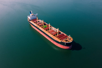 Shipping cargo to harbor by ship. Water transport International. Aerial view