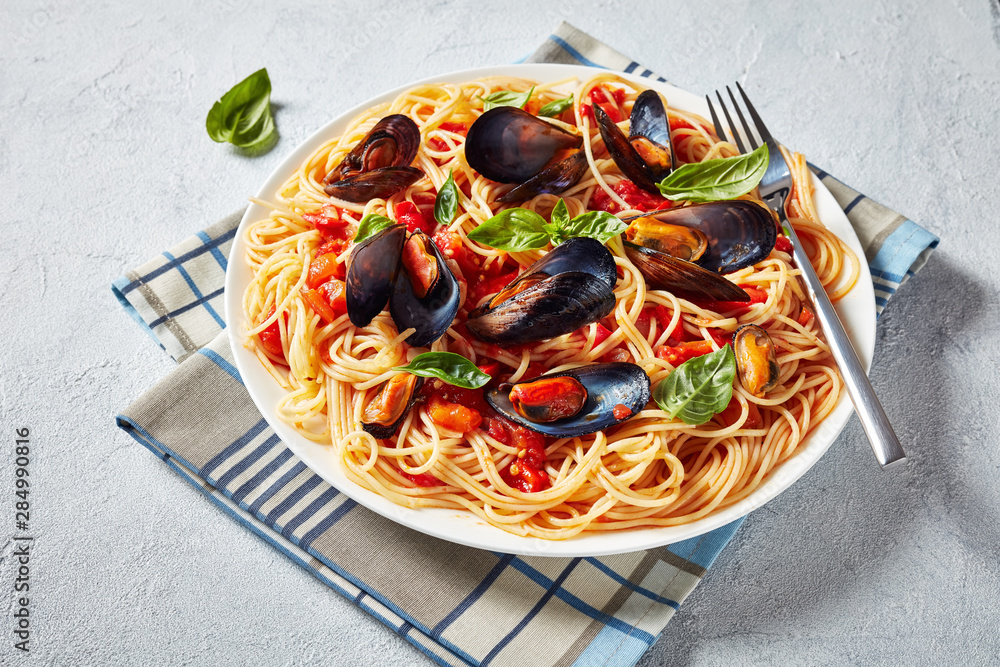 Sticker pasta with mussels on a white platter