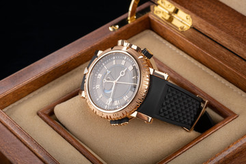 wrist watch packed in open wooden box. roman dial