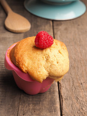 Raspberry muffin on a wooden table