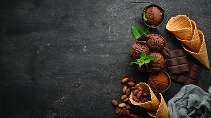 Ice cream with chocolate. Making ice cream on Wooden background. Top view. Free space for your text.