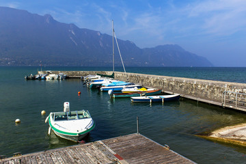 Fototapeta na wymiar mediterranean mountain coast landscape boats in harbor