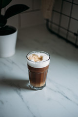 Coffee latte macchiato with vegan coconut milk in a glass