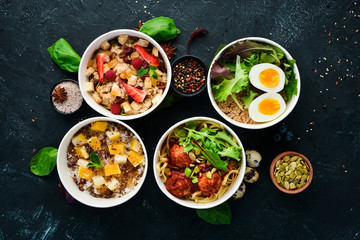 Food with delivery. A set of dishes for the diet. Top view. Free space for your text. On a black background.