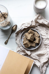 Portion of halva with vanilla and sunflower seeds on marble background with copy space