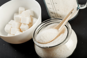 bowl of sugar  on black background