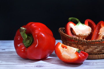 slices of red paprika on table top  isolated on black