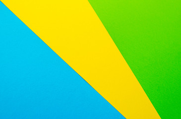 Colored paper: green, blue, yellow. Abstract colorful background, top view. Copy space, banner template. Flat lay
