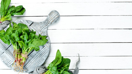Fresh spinach on a white background. Healthy food. Top view. Free space for your text.