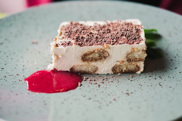Tiramisu. A spoon breaks off a piece of tiramisu cake.
