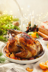 Homemade whole baked Christmas stuffed chicken with tangerines