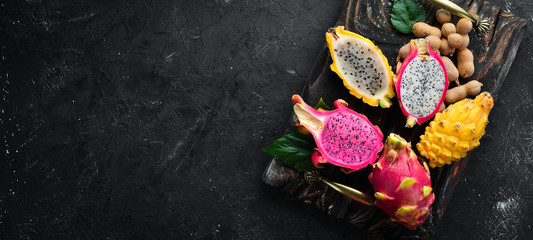Obraz na płótnie Canvas Fresh Dragon Fruit on a Black Background. Tropical Fruits. Top view. Free space for text.