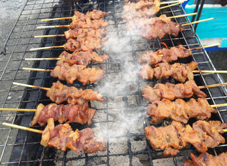 tasty slice pork on the grilled with flames and charcoal  ,thai street food