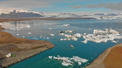 Fototapeta premium Jokullsarlon glacial lake in southwest Iceland. Panoramic aerial view of icebergs in the lagoon on a sunny day