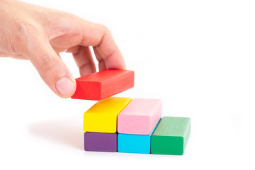 Businessman hand holding wooden block on white background. Business concept. Planning, risk management, solution and strategy.