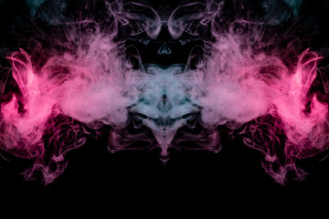 Smoke of different blue, red and pink colors in form of horror in the shape of the head, face and eye with wings on a black isolated background. Soul and ghost in mystical symbol. Print for clothes.