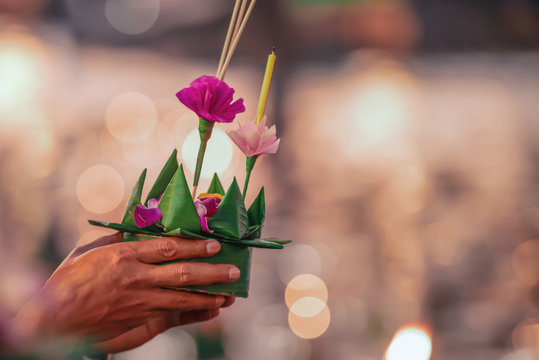 Paper lotus flower with candle floating on a river at night in Loy krathong festival, traditional Siamese new year festival celebrated in Thailand.