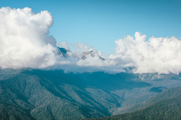 Beautiful view of the mountains with big clouds in blue sky. Krasnodar area, Sochi